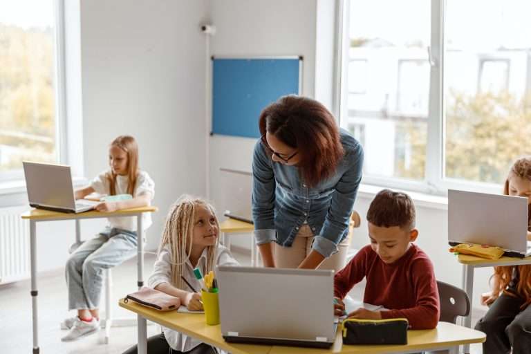 Tutor explaining the task to children at tutoring center.